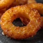 Air Fryer Caramelized Pineapple Rings: Close-up of golden air fryer caramelized pineapple rings with glistening brown sugar crust and juicy yellow interior.