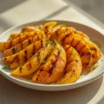 air fryer grilled mango: Golden air fryer grilled mango wedges with caramelized edges and glossy cinnamon oil sheen on a warm plate.