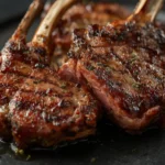 air fryer lamb chops: Golden brown air fryer lamb chops with rosemary and garlic, juicy interior visible