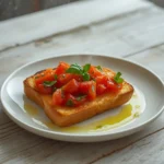 air fryer bruschetta toast: Golden crispy air fryer bruschetta toast topped with juicy tomatoes and fresh basil.