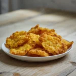 air fryer dill pickle chips: Golden crispy air fryer dill pickle chips on a plate with creamy dip.