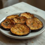 air fryer eggplant rounds: Golden crispy air fryer eggplant rounds with spice coating on a plate