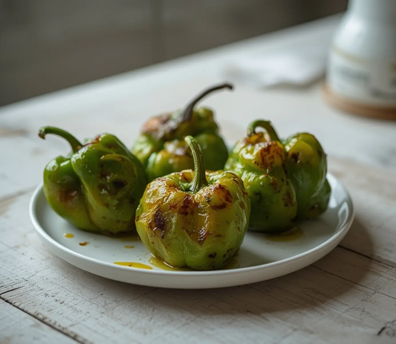 air fryer shishito peppers: Golden, blistered shishito peppers with crisp edges in an air fryer basket, perfect for Crispy Air Fryer Sides.