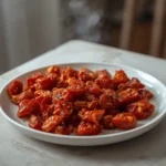 air fryer sun dried tomatoes: Crispy air fryer sun dried tomatoes with golden edges in a white bowl