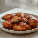 Air Fryer Honey Soy Chicken: Golden brown honey soy chicken pieces with sticky glaze in air fryer basket