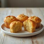 Air Fryer Lemon Poppyseed Muffins: Golden brown air fryer lemon poppyseed muffins with a tender crumb and poppyseed specks on a rustic board.
