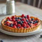 Air Fryer Patriotic Berry Tart: Golden patriotic berry tart in air fryer with red, white, and blue fruit and crisp crust.