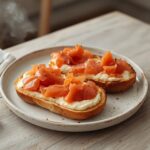 Air Fryer Smoked Salmon Bagel: Golden air fryer smoked salmon bagel with crispy edges and ruby-red salmon topping on a rustic board.