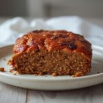 Air Fryer Turkey Meatloaf: Golden brown air fryer turkey meatloaf with a glistening ketchup glaze and crisp edges on a white plate.