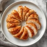 Perfectly sliced and seasoned Air Fryer Frozen Chicken breast served on a clean white plate