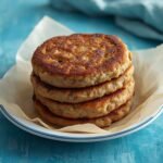 A rustic plate piled high with golden brown Air Fryer Sausage Patties for breakfast.